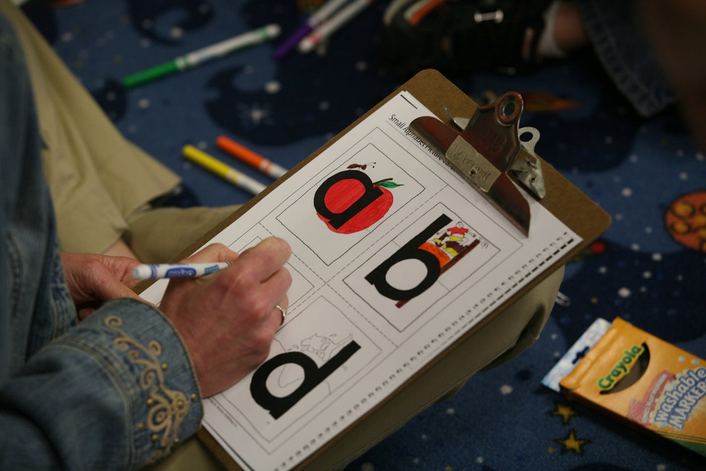 A reading teacher at Centennial Elementary School in Circle Pines colored around letters of the alphabet with kindergarten students in 2008.