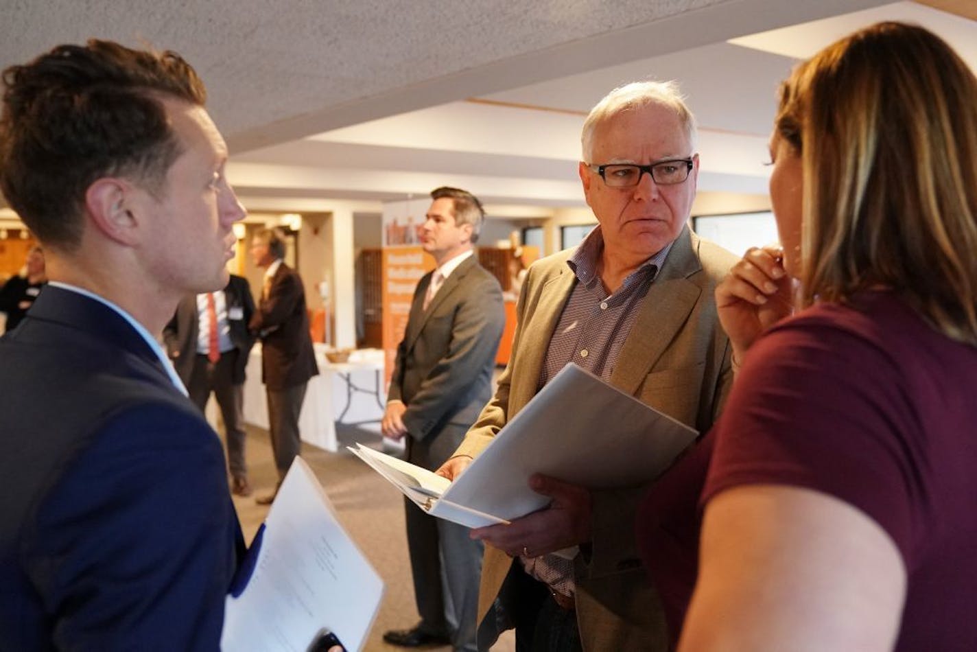 Gubernatorial candidate Tim Walz conferred with staff members before speaking on the opioid crisis at the Hazelden Betty Ford Event Pathways and Partnership Conference Friday, Sept. 28, 2018 in Woodbury, Minn.