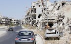 Damaged buildings and rubble line a street in Homs, Syria, Sept. 19, 2016. Syria&#x2019;s military command has declared the U.S-Russian brokered cease