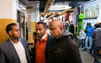 From left, Mohammedamin Kahin, Mukhtar Yusuf, and Mahamud Sharif Abdi on Friday at Village Market mall discussed their reactions to President Donald T