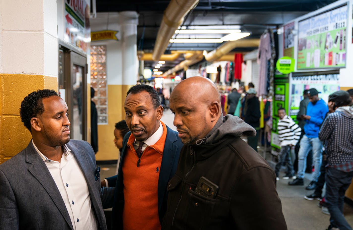 From left, Mohammedamin Kahin, Mukhtar Yusuf, and Mahamud Sharif Abdi on Friday at Village Market mall discussed their reactions to President Donald Trump's visit to Minneapolis the day before.