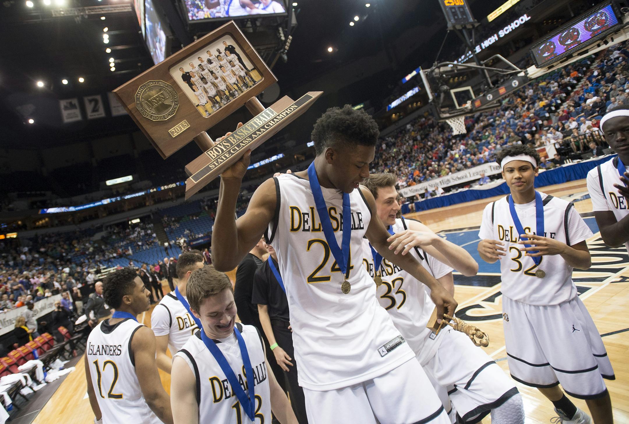 DeLaSalle forward Joshua Collins (24) hoists his team's 3A championship trophy over his head after defeating St. Paul Johnson 82-64. ] (Aaron Lavinsky | StarTribune) St. Paul Johnson takes on DeLaSalle in the Class 3A boys' basketball championship game on Saturday, March 14, 2014 at Target Center.