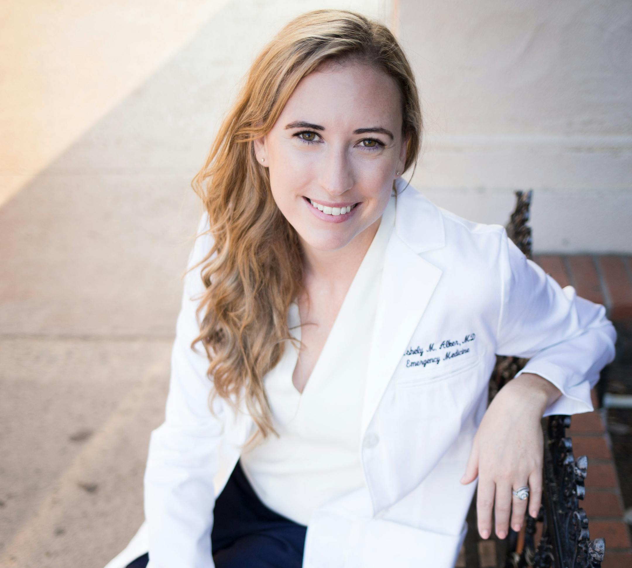 photo of author Ashely Alker in a physician's coat