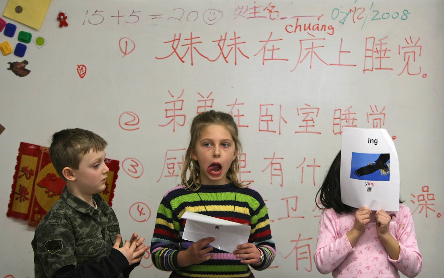 From left, Excelsior Elementary School first-graders Garret Erb, Danna Engeman and Meili Gong worked on Mandarin Chinese language drills. The Minnetonka School District's Mandarin immersion program has two kindergarten classes and one first-grade class but will be expanding the classes as the kids advance.