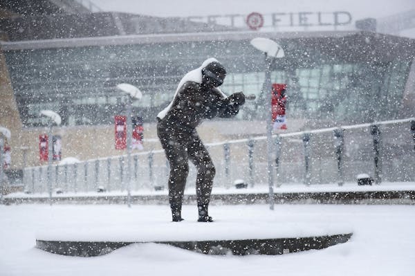 A statue of former Twin and multiple time All-Star Rod Carew is coated in fresh snow