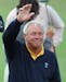 Arnold Palmer waved to the crowds on the 18th green at St. Andrews Old Course, July 21, 1995, during the second round of the British Open.