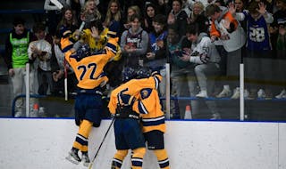 Mahtomedi’s Carter Haycraft (22) and teammates headed to the glass to celebrate a goal.
