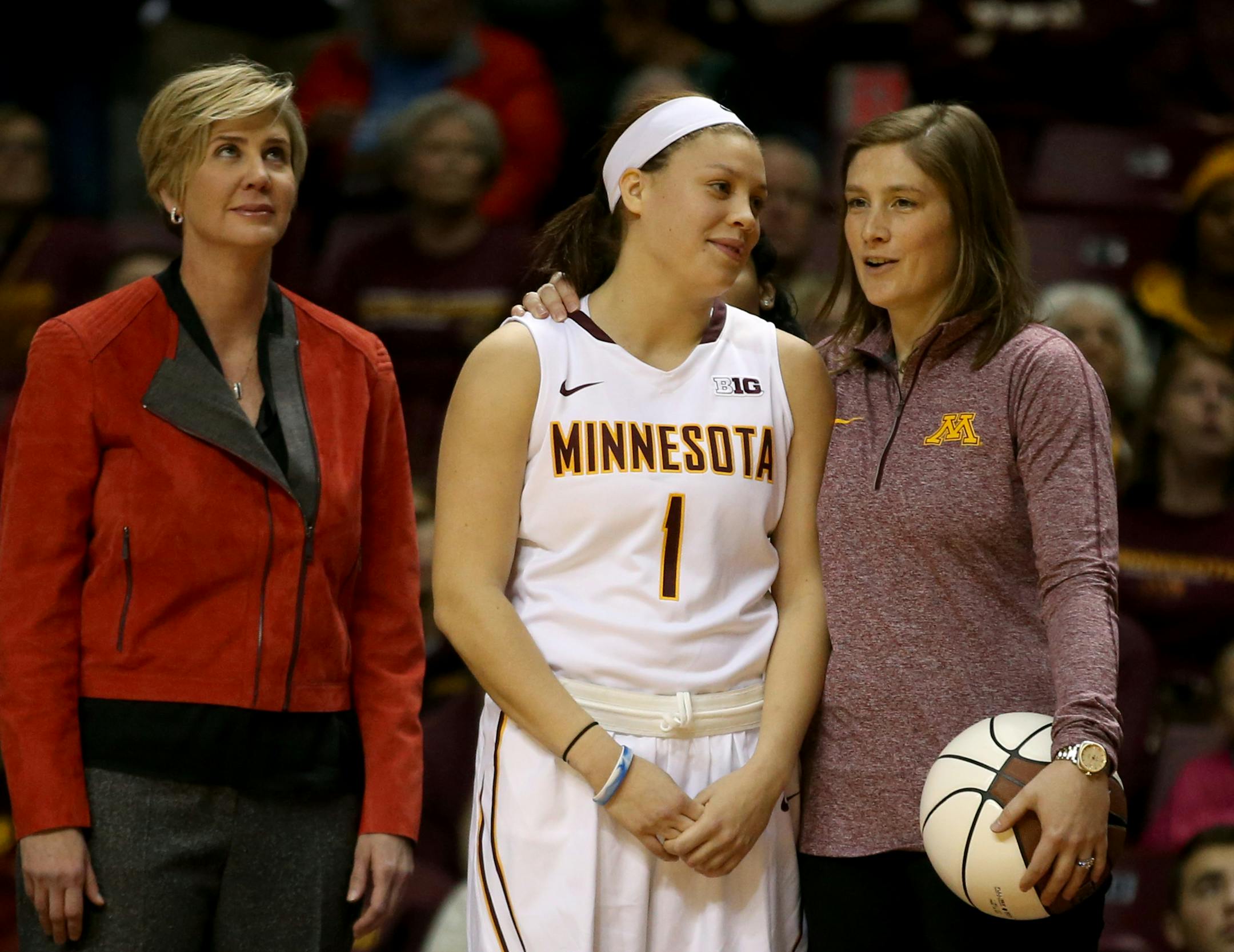 Lindsay Whalen chatted with Rachel Banham as a highlight video played to honor Banham as the Gophers' all-time leading scorer before Saturday's game against Memphis.