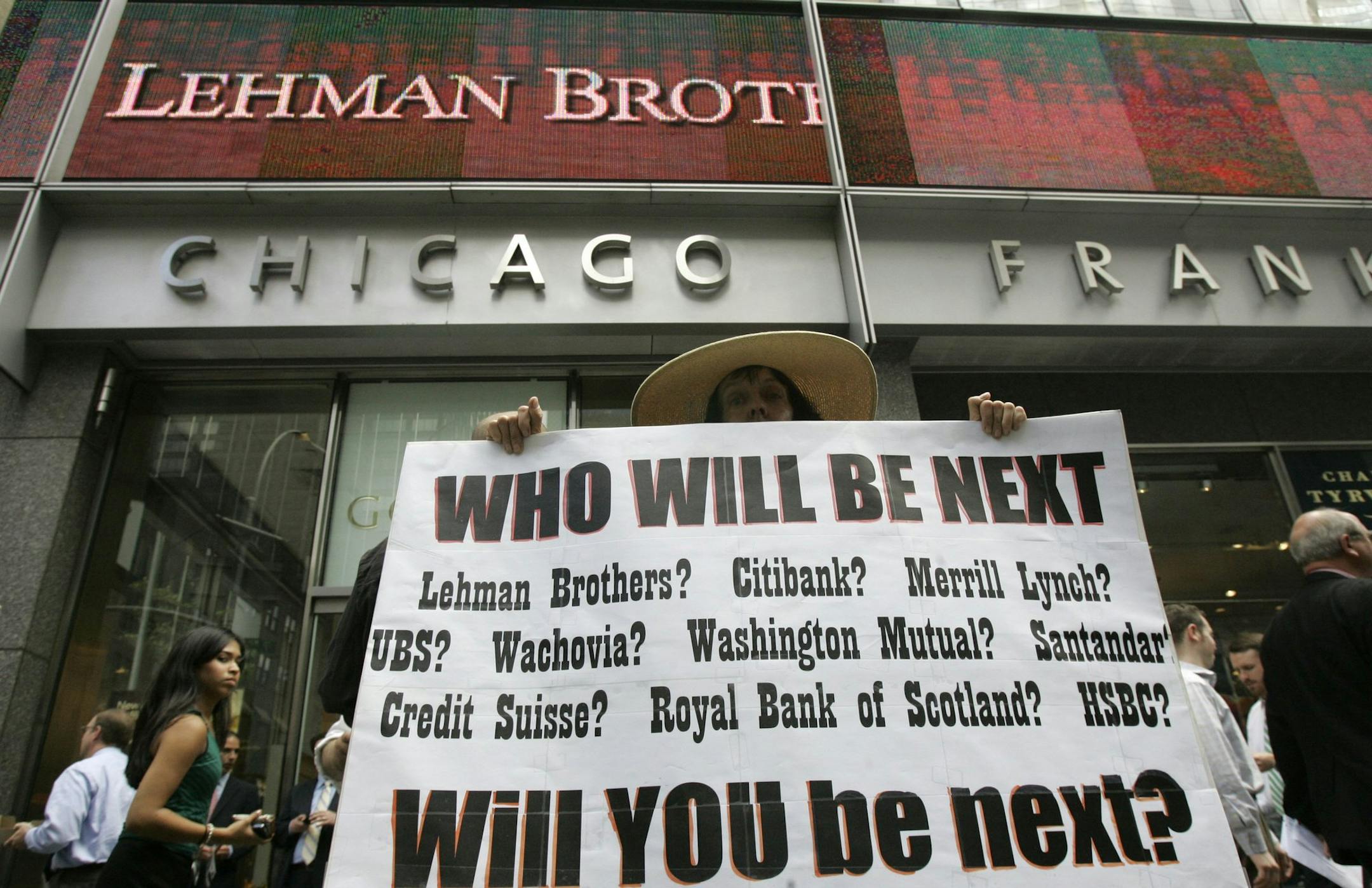 ** FOR USE SUNDAY, SEPT. 6 AND THEREAFTER ** FILE - In this Monday, Sept. 15, 2008 file photo, Robin Radaetz holds a sign in front of the Lehman Brothers headquarters in New York. That day, Lehman Brothers, a 158-year-old investment bank choked by the credit crisis and falling real estate values, filed for Chapter 11 protection in the biggest bankruptcy filing ever. (AP Photo/Mary Altaffer, file) ORG XMIT: MIN2013090915040965
