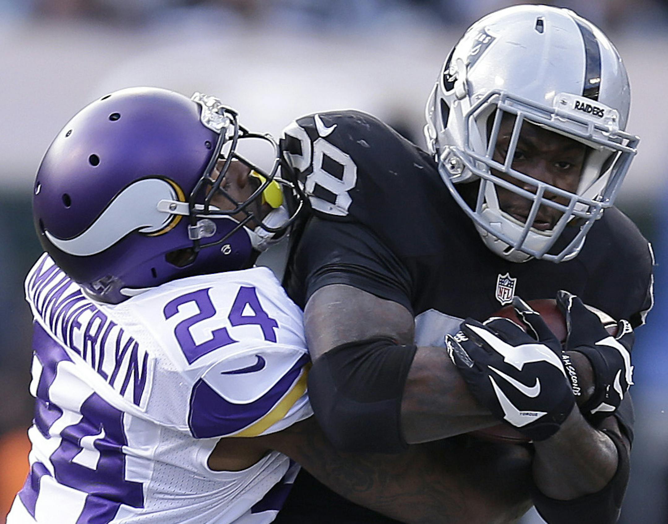 Minnesota Vikings cornerback Captain Munnerlyn (24) tackles Oakland Raiders running back Latavius Murray (28) during the first half of an NFL football game in Oakland, Calif., Sunday, Nov. 15, 2015. (AP Photo/Ben Margot) ORG XMIT: MIN2015111620014778