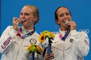 Delaney Schnell and Jessica Parratto, right, posed with their silver medals Tuesday in Tokyo.