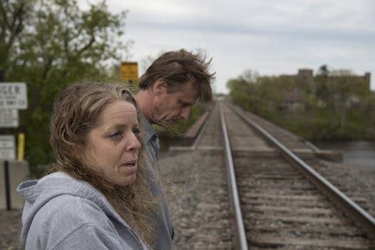 Dave Dady and his wife, Kelly Dady, near the St. Cloud train trestle where his 21-year-old son, Jesse, likely fell into the Mississippi River and drowned in March.