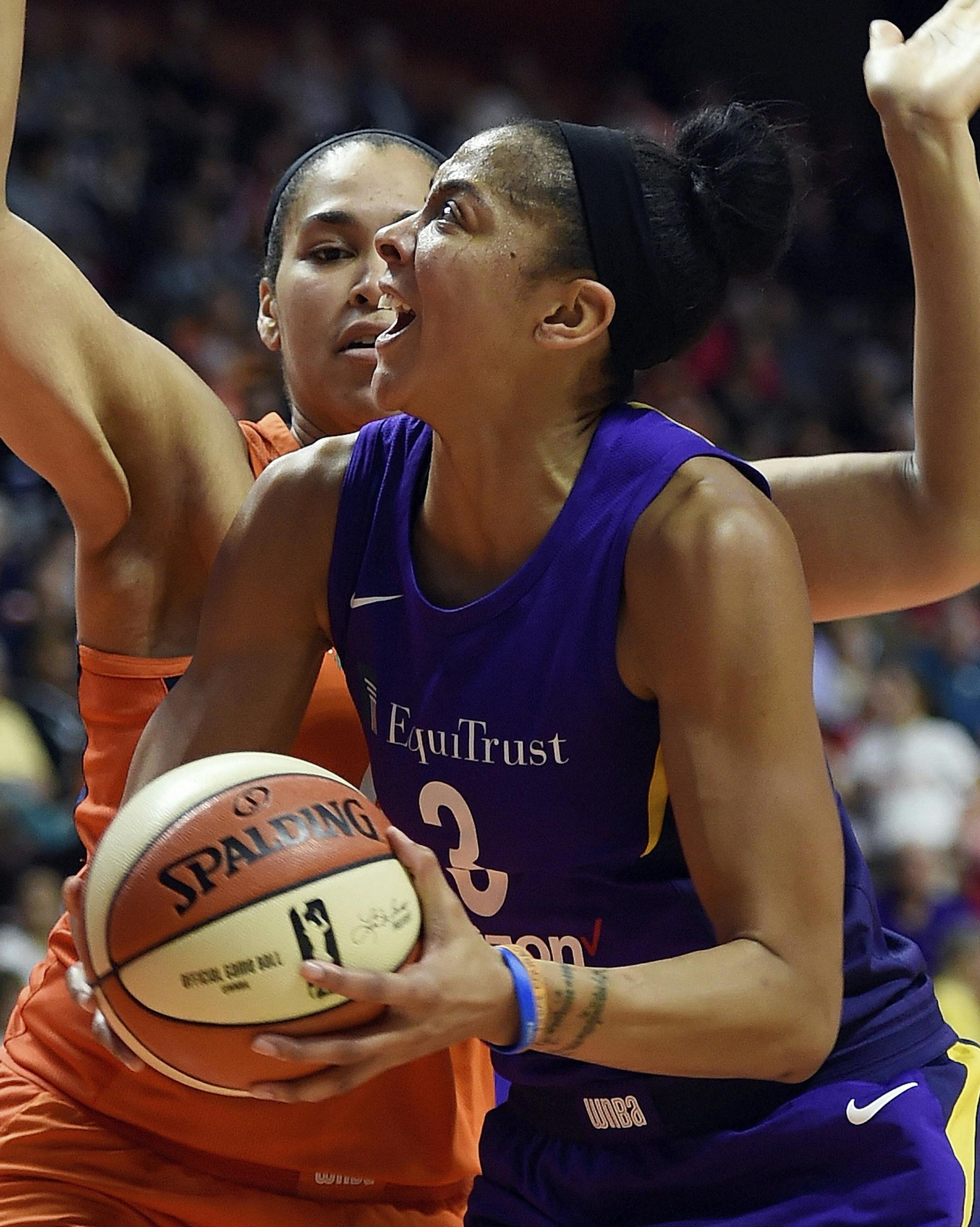 Los Angeles Sparks forward Candace Parker drives to the basket as Connecticut Sun center Brionna Jones defends in the first half of a WNBA basketball game Sunday, Aug. 19, 2018, in Uncasville, Conn. (Sean D. Elliot/The Day via AP) ORG XMIT: MIN2018082019300447