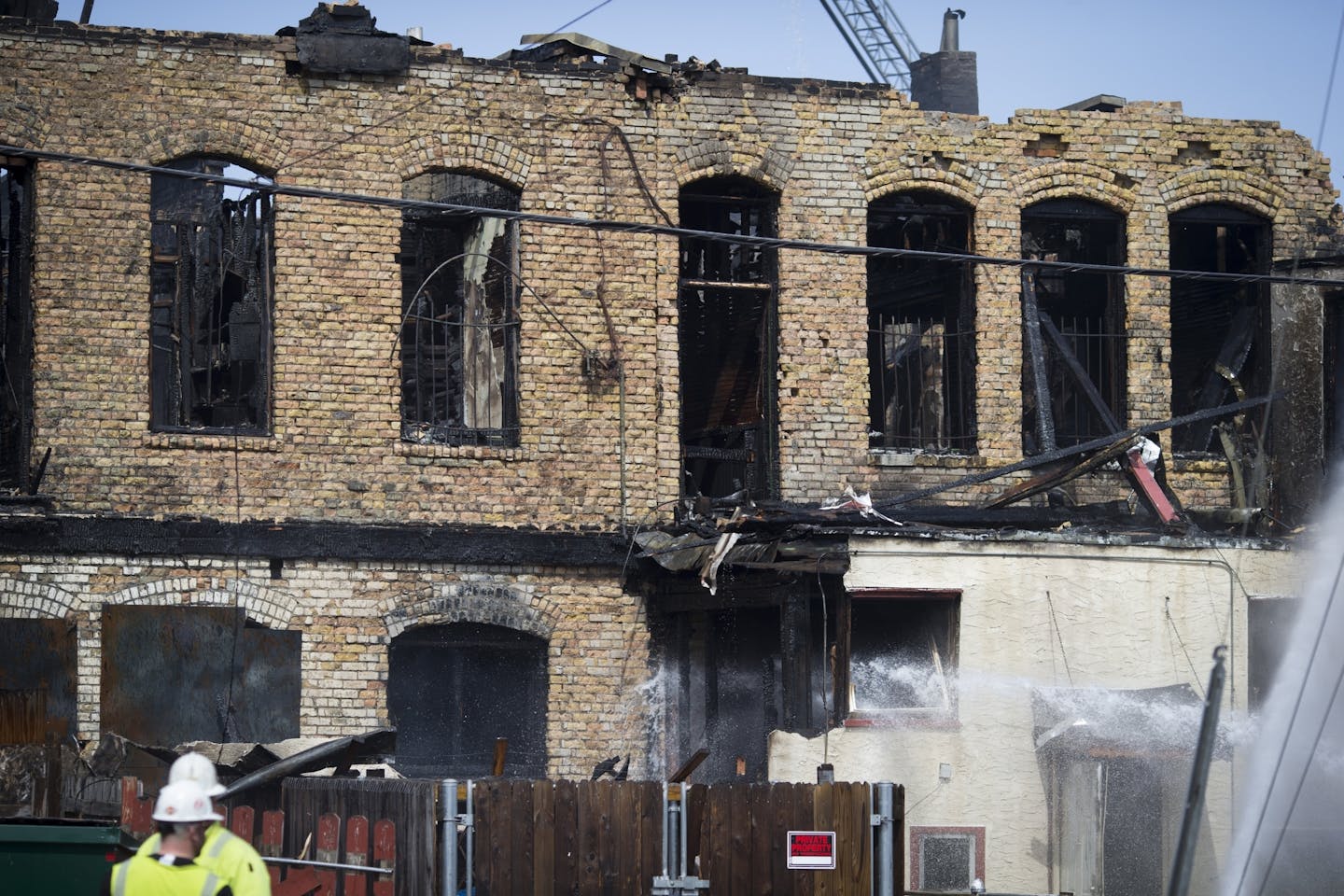 Fire fighters continued to to hose water on a fire that broke out on the 900 block of W Broadway in Minneapolis, Minn., on Wednesday, April 15, 2015.