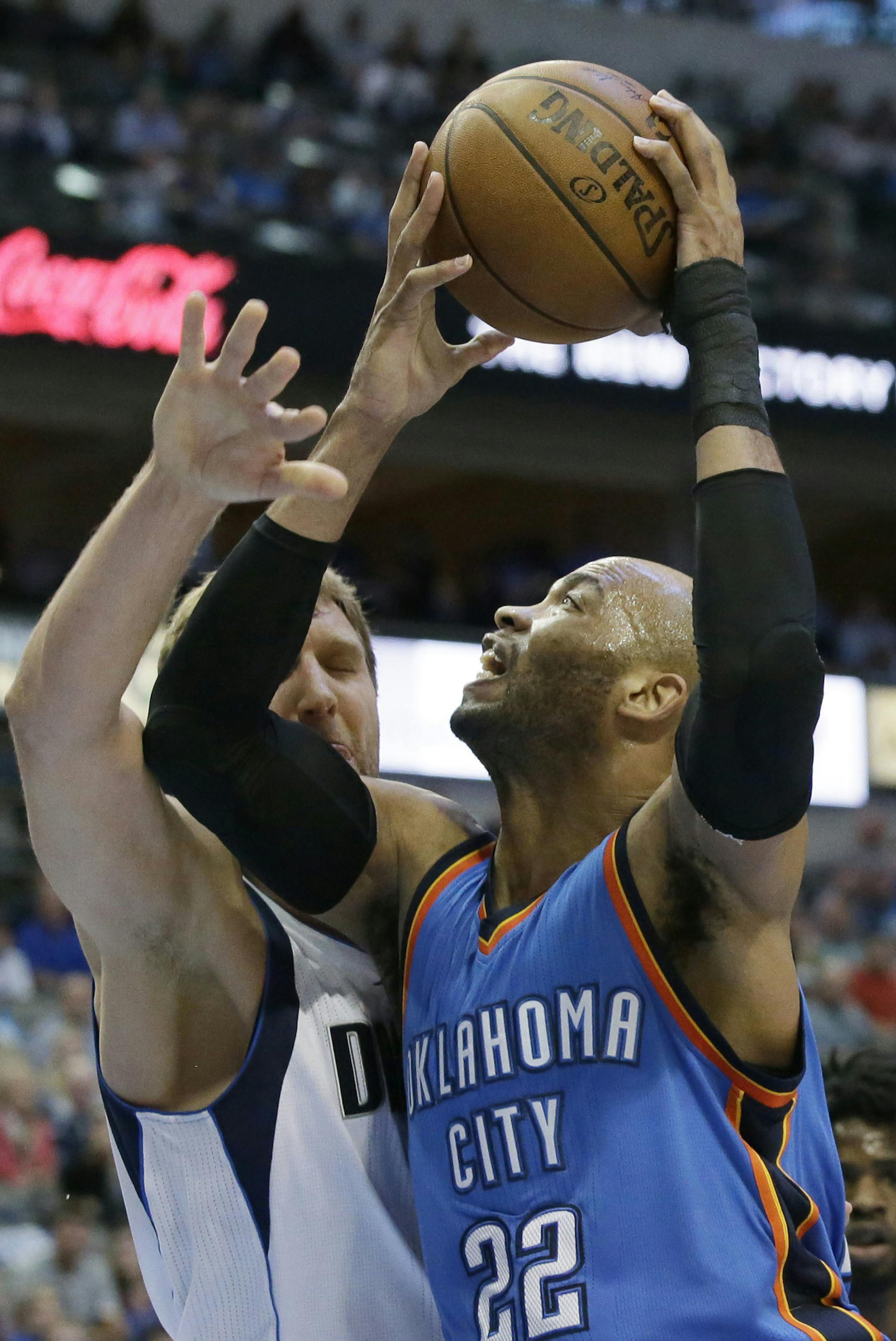 Oklahoma City Thunder forward Taj Gibson (22) drive against Dallas Mavericks forward Dirk Nowitzki (41) of Germany during the first half of an NBA basketball game in Dallas, Monday, March 27, 2017. (AP Photo/LM Otero) ORG XMIT: DNA102 ORG XMIT: MIN1707021651421207