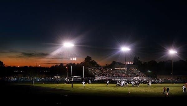 Back when they played: Delano High School is aglow beneath lights and a setting sun.