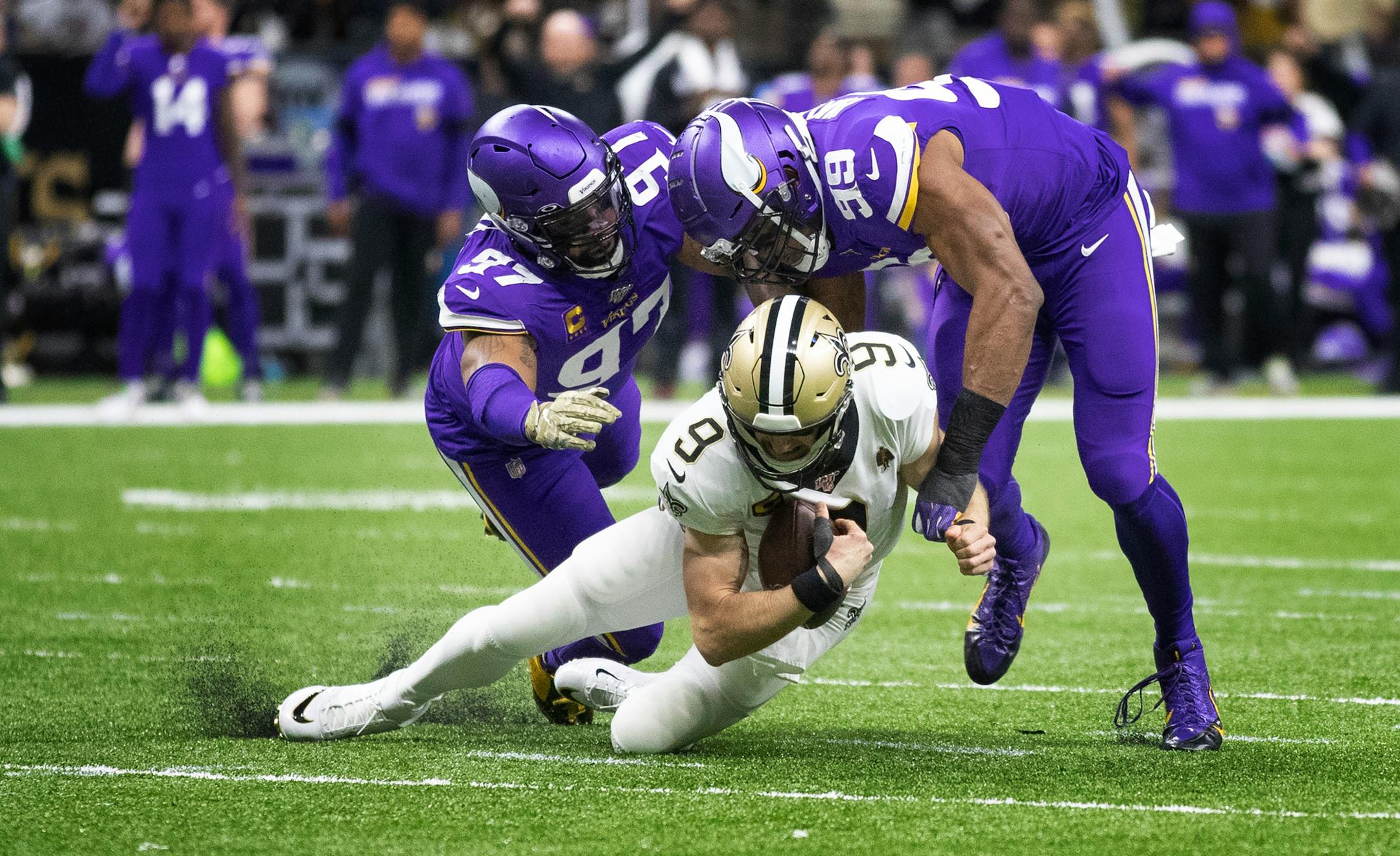 Vikings defensive end Everson Griffen (97) and Danielle Hunter (99) tackled Saints quarterback Drew Brees in the first quarter.