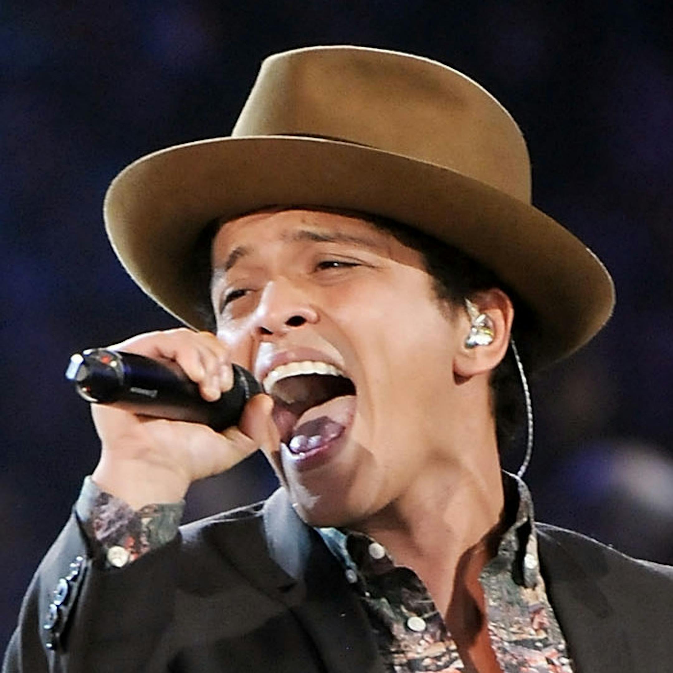 FILE - This Nov. 7, 2012 file photo shows Bruno Mars performing during the 2012 Victoria's Secret Fashion Show in New York. Sting, Rihanna and Bruno Mars will hit the stage for a special performance at next week's Grammy Awards. The Recording Academy announced Monday, Feb. 4, 2013, that they will perform together at the Feb. 10 awards show. Triple nominee Kelly Clarkson will also take the stage. (Photo by Evan Agostini/Invision/AP) ORG XMIT: MIN2013022016594866