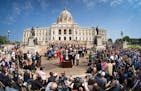 Gov. Tim Walz attends a bill-signing party on May 24 celebrating a jam-packed legislative session on the Capitol steps in St. Paul with supporters, le