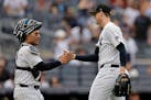 Yankees pitcher Clay Holmes (35) celebrates with catcherr Jose Trevino after their victory over the White Sox on Sunday in New York.