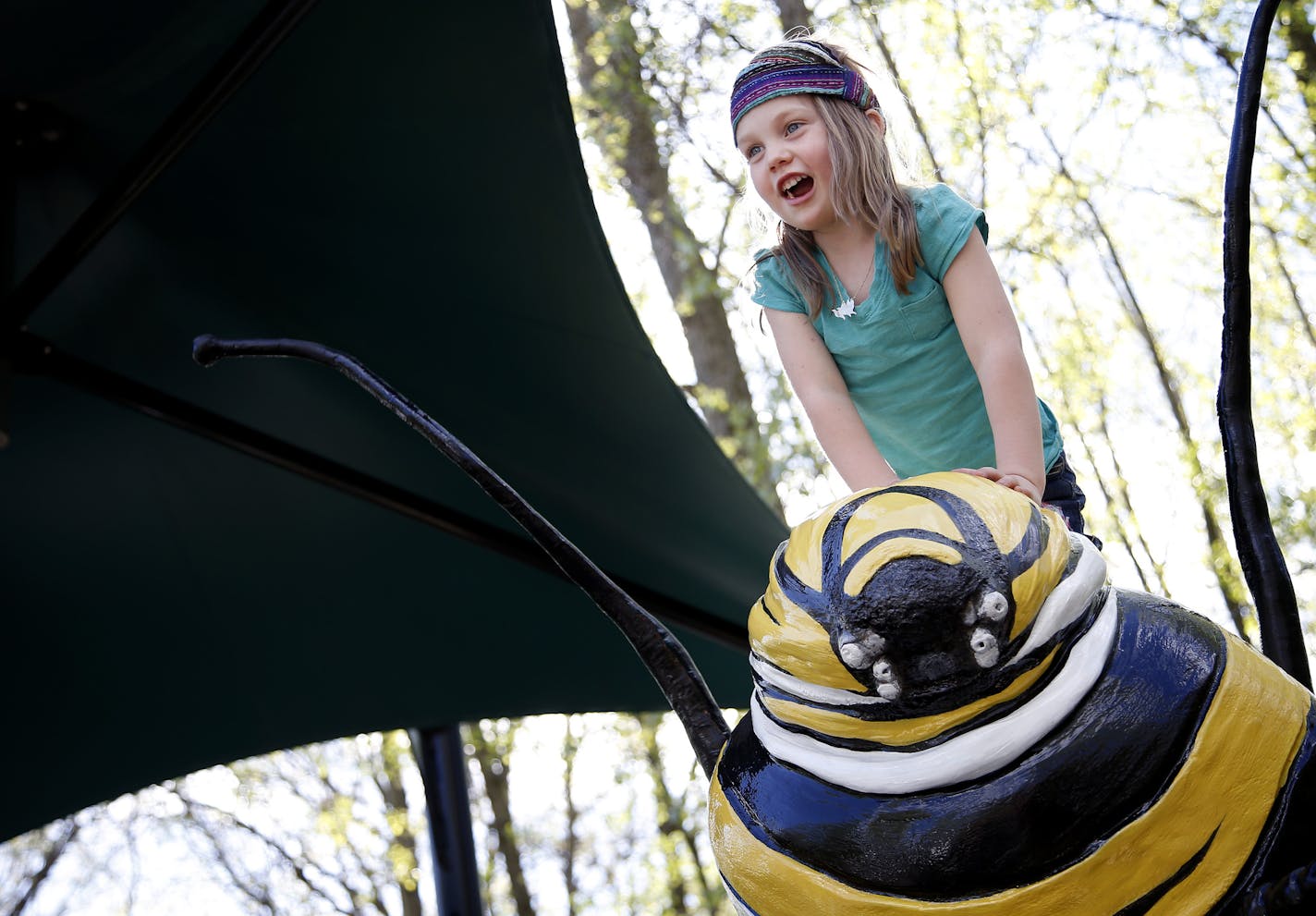 Stella Appleton, 4, of West St. Paul played on a Monarch caterpillar model at the Minnesota Zoo on Wednesday. ] CARLOS GONZALEZ cgonzalez@startribune.com - May 21, 2014, Apple Valley, Minn., Minnesota Zoo, MN Zoo's big show of the summer, Big Bugs!, which has several added Minnesota-specific buggy elements in addition to the giant animatronic insects.