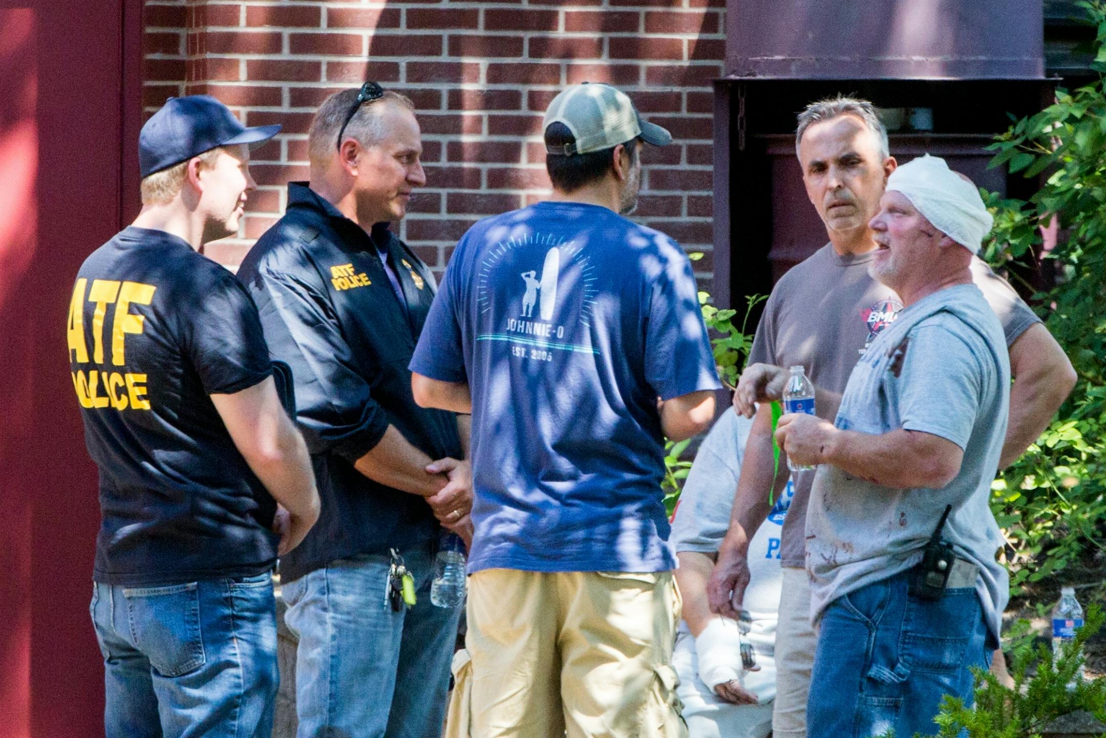 ATF officers speak to people outside of Minnehaha Academy following an explosion and partial building collapse on Aug. 2, 2017.