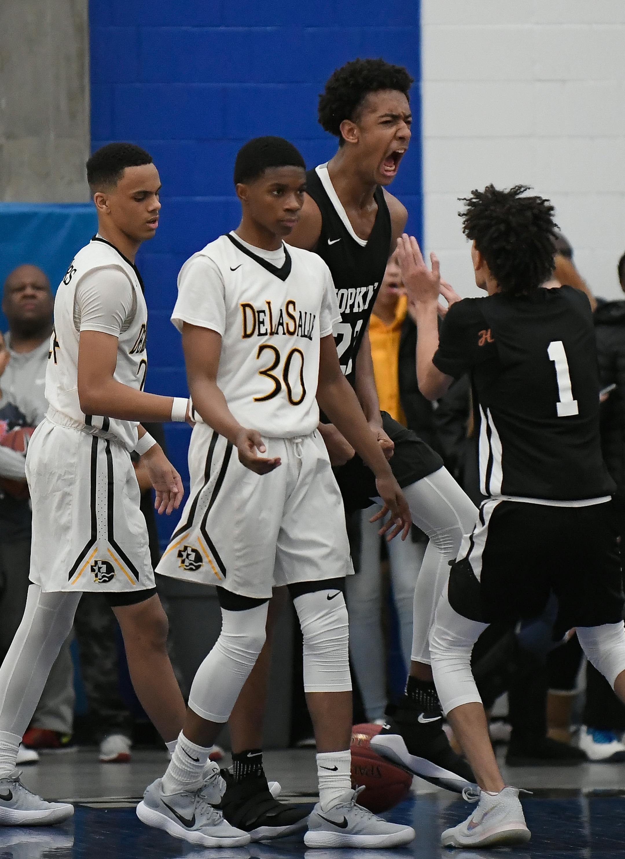 DeLaSalle forward Christian Dickson (24) and guard Rayquan Moore (30) were dejected as Hopkins forward Zeke Nnaji (22) and guard Blaise Beauchamp (1) celebrated a late 2-point layup to put the game out of DeLaSalle's reach in the final moments of the second half Saturday. ] AARON LAVINSKY ï aaron.lavinsky@startribune.com DeLaSalle played Hopkins in a boys high school basketball game on Saturday, Dec. 9 , 2017 in the Breakdown Classic at Hopkins High School in Hopkins, Minn.