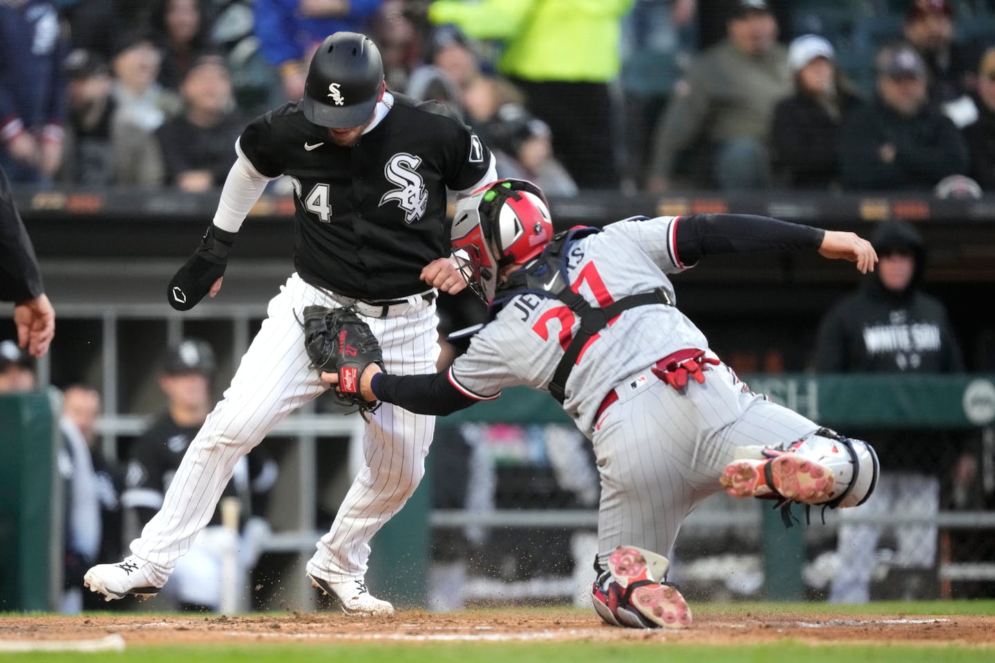 Minnesota Twins catcher Ryan Jeffers tags Chicago White Sox's Yasmani Grandal out at home to end the fourth inning of a baseball game on Wednesday, May 3, 2023, in Chicago. (AP Photo/Charles Rex Arbogast)