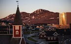 FILE - In this Monday, July. 31, 2017 file photo the sun sets over Nuuk, Greenland. A spokeswoman for Denmark's royal palace says U.S. President Donal