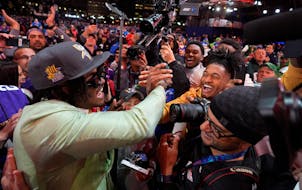 Alabama linebacker Dallas Turner celebrates with fans after being chosen by the Minnesota Vikings with the 17th overall pick in the first round of the