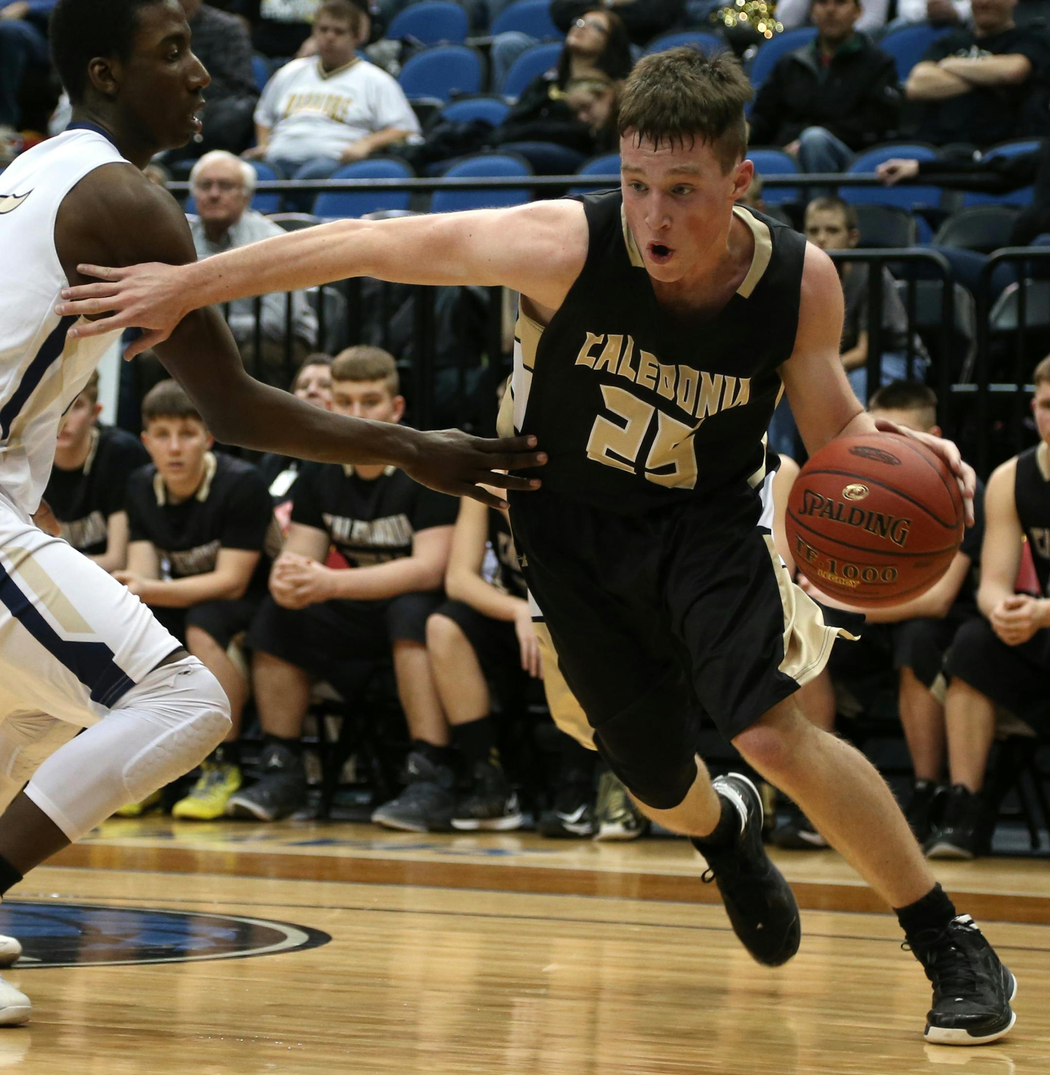Caledonia's Austin Bauer drove around St. Paul Academy/Summit School' s Dalante Peyton in the second half. ] (KYNDELL HARKNESS/STAR TRIBUNE) kyndell.harkness@startribune.com During the state championship 2A quarterfinals at the Target Center in Minneapolis, MN Wednesday, March 12, 2014. Caledonia won over St. Paul Academy/Summit School 73-53.