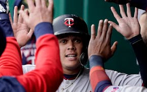 Minnesota Twins' Gio Urshela celebrates in the dugout after scoring on a sacrifice fly by Byron Buxton during the third inning of a baseball game Satu