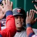Minnesota Twins' Gio Urshela celebrates in the dugout after scoring on a sacrifice fly by Byron Buxton during the third inning of a baseball game Satu