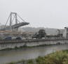 A view of the collapsed Morandi highway bridge in Genoa, northern Italy, Tuesday, Aug. 14, 2018. A large section of the bridge collapsed over an indus