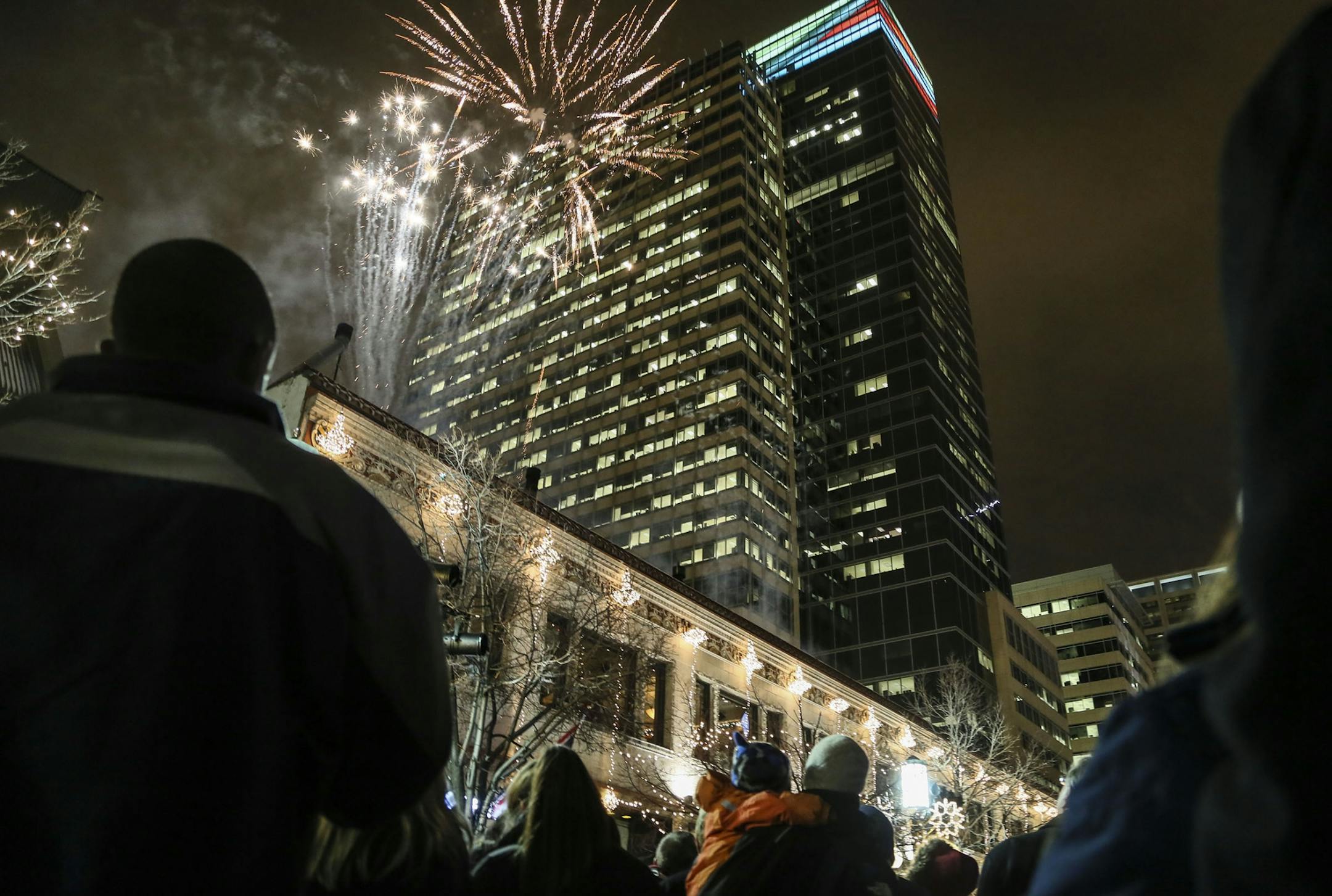 This is the first year of the reimagined Holidazzle, where it's Holidazzle Village, rather than the Holidazzle parade. Here, fireworks light the cold night sky over downtown Minneapolis, launched from Vincent's Friday, Nov. 28, 2014.