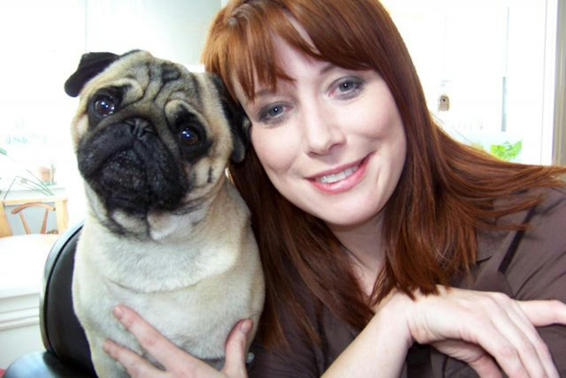 Author Heather McElhatton poses with her Chinese pug Walter at her home in Minneapolis.