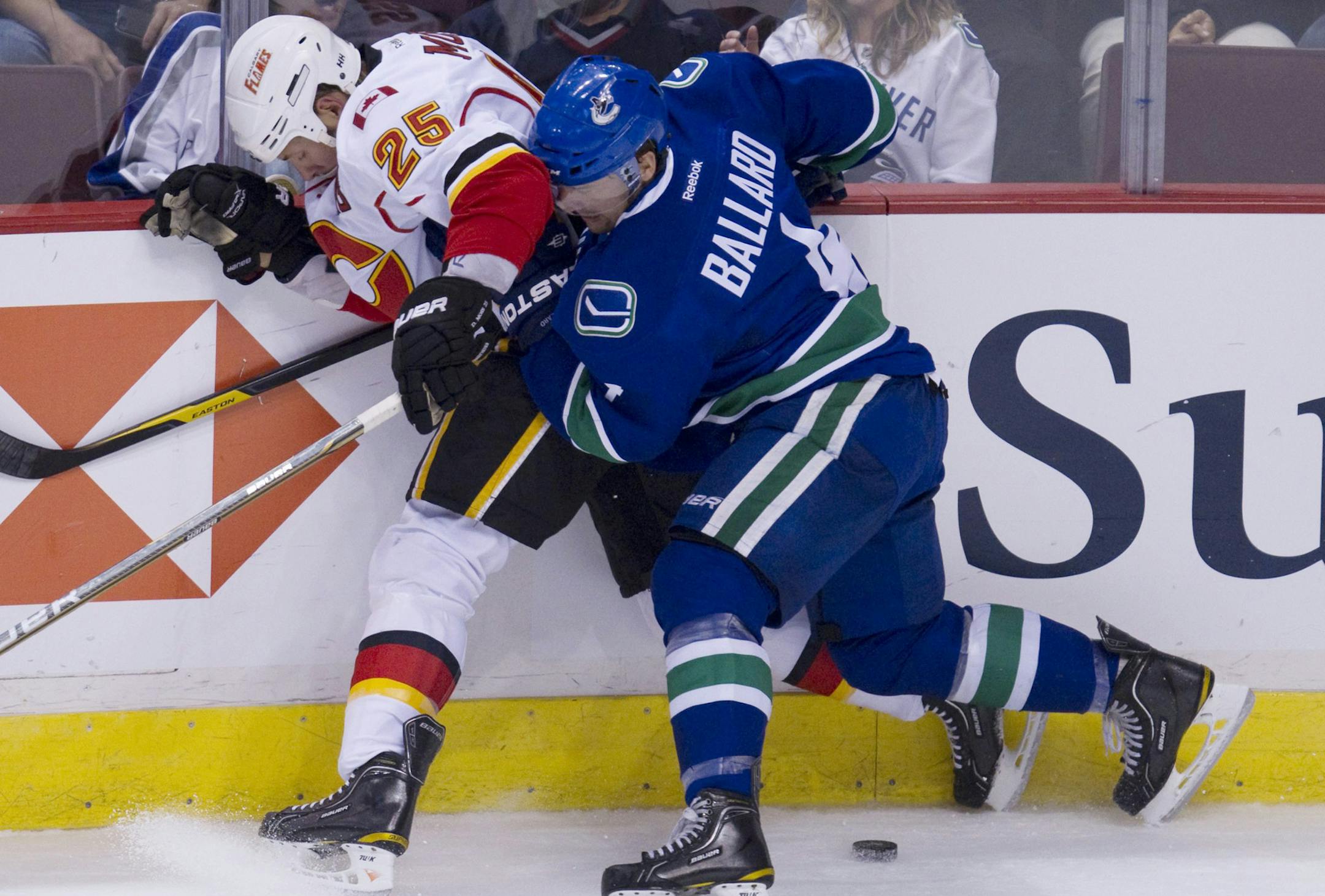 Defenseman Keith Ballard (right), shown fighting for control of the puck when he was with the Vancouver Canucks, is joining the Wild this season. Ballard attended the University of Minnesota, where he helped win two national championships.