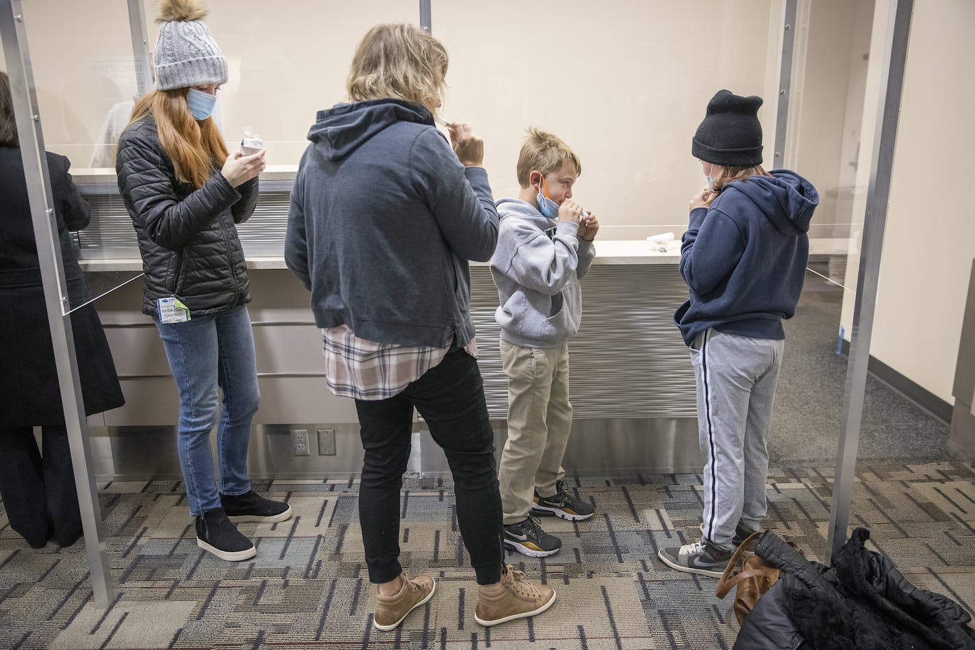 Heidi Smith and her children, Ella, 15, Nolan, 8, and Amelia, 12, took advantage of the new saliva COVID-19 testing site at the Minneapolis-St. Paul International Airport on Thursday.