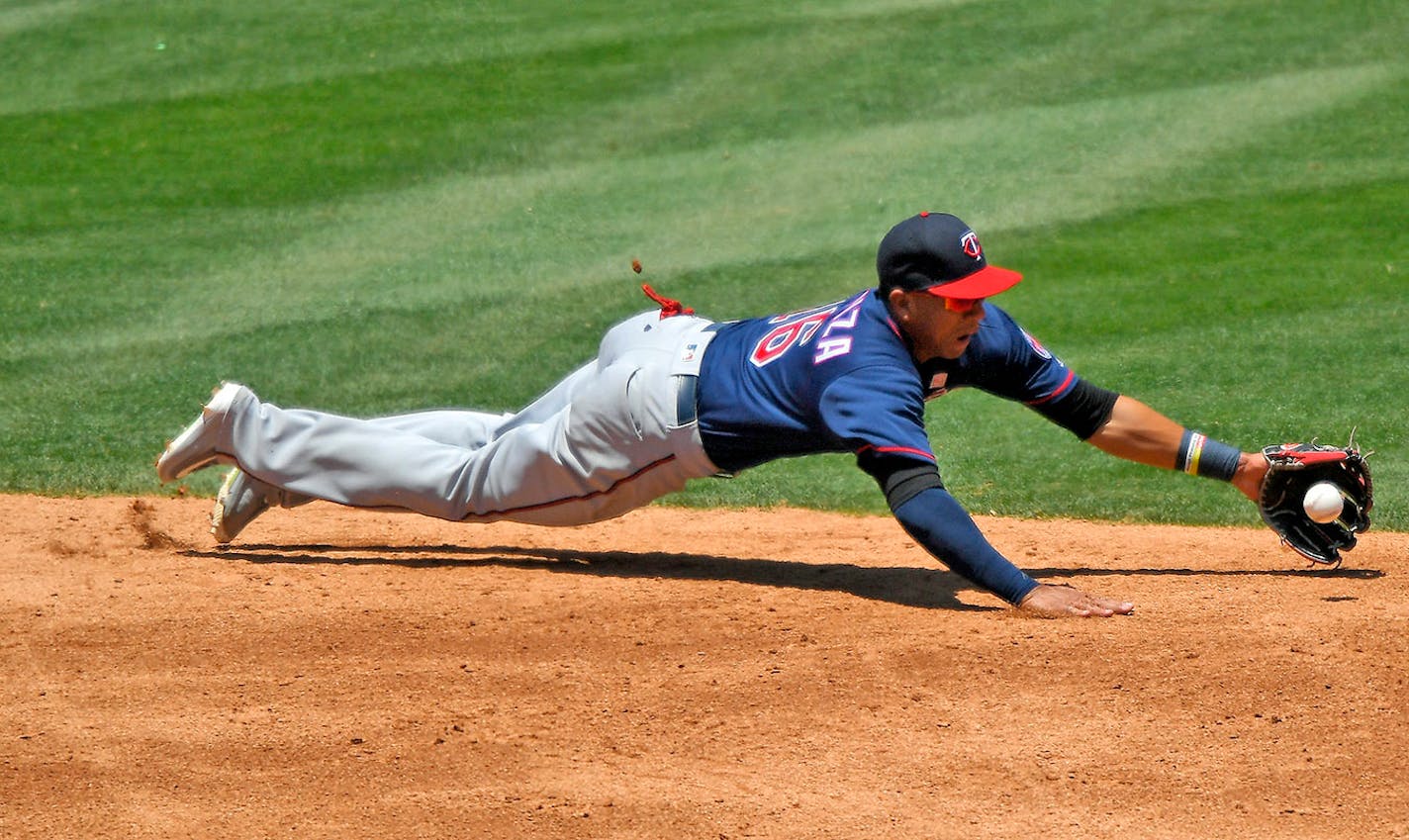 Minnesota Twins shortstop Ehire Adrianza cannot reach a ball hit for a single by Los Angeles Angels' Kole Calhoun during the third inning of a baseball game, Sunday, June 4, 2017, in Anaheim, Calif.