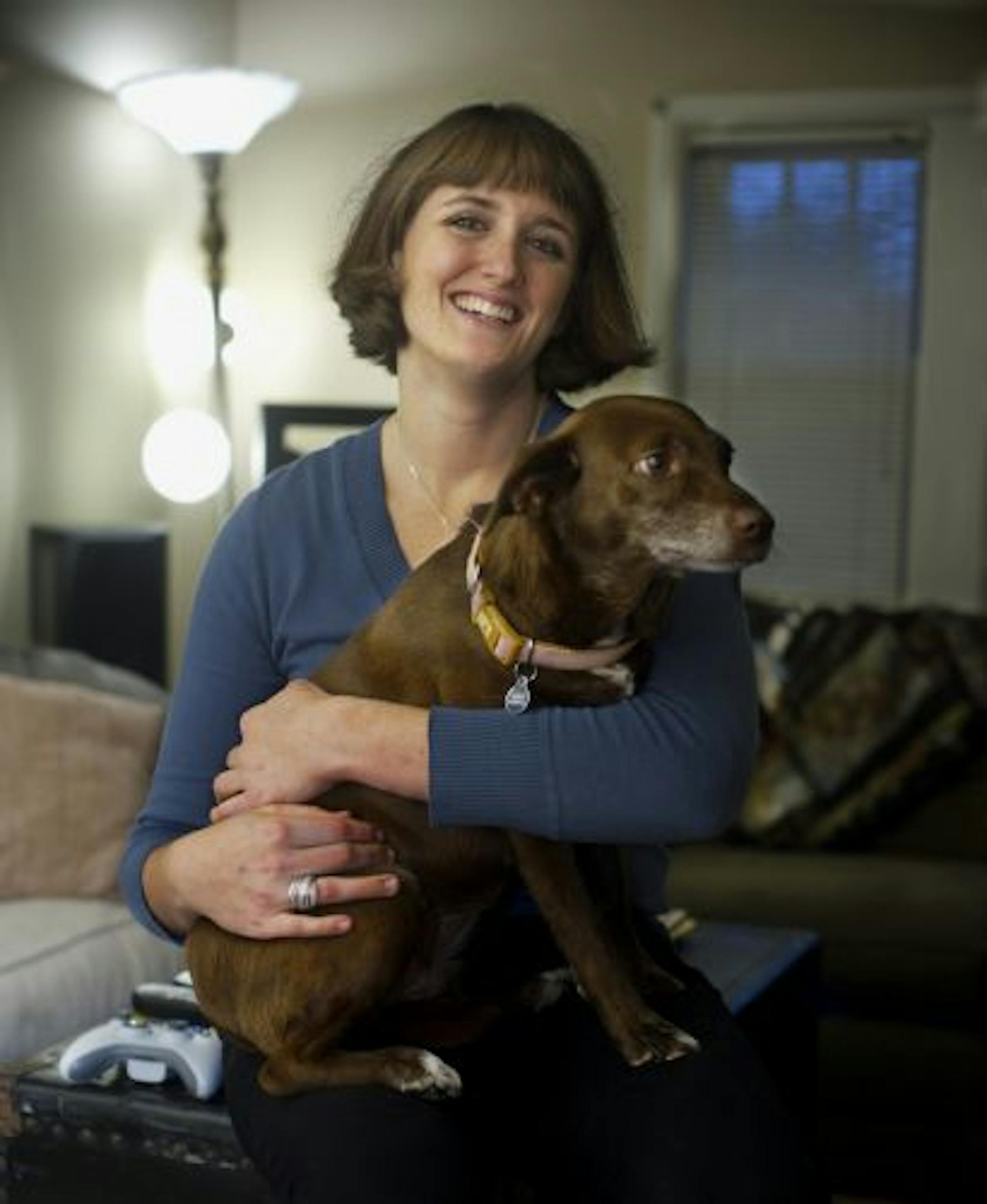 Crystal Donelan, pictured in her Minneapolis apartment with her dog, Floyd, likes knowing she can move when she wants to.