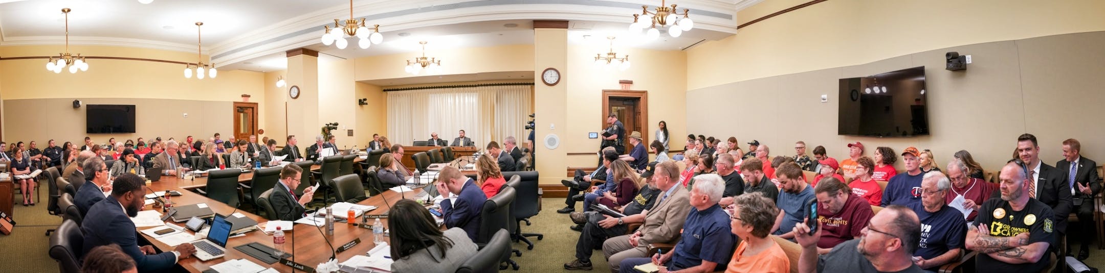 Rep. Dave Pinto, D-St. Paul, listened while Rob Doar of the Minnesota Gun Owners Caucus spoke against his bill in the Public Safety conference committee that was packed by advocates of both sides.