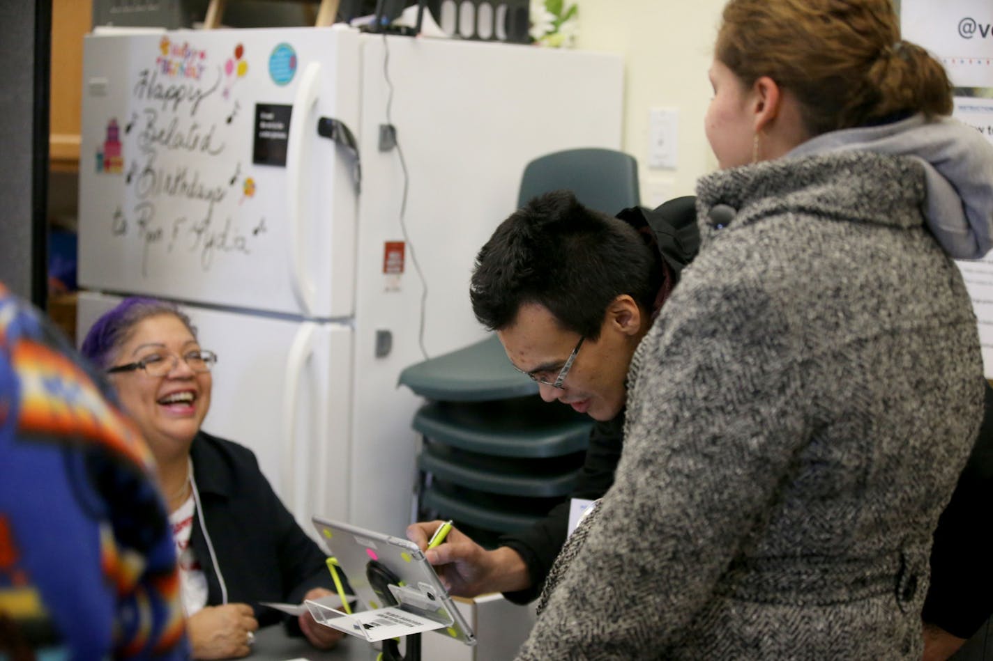 Lance LaMont of Minneapolis, middle, vouches for Karina Murphy, 22, right, who lives in the Hiawatha homeless encampment, before Murphy voted for the first time Tuesday, Nov. 6, 2018, at the Little Earth polling place in Minneapolis, MN. LaMont said he volunteered to help some of the homeless at the encampment "to give some of the most disenfranchised members of the community a voice."