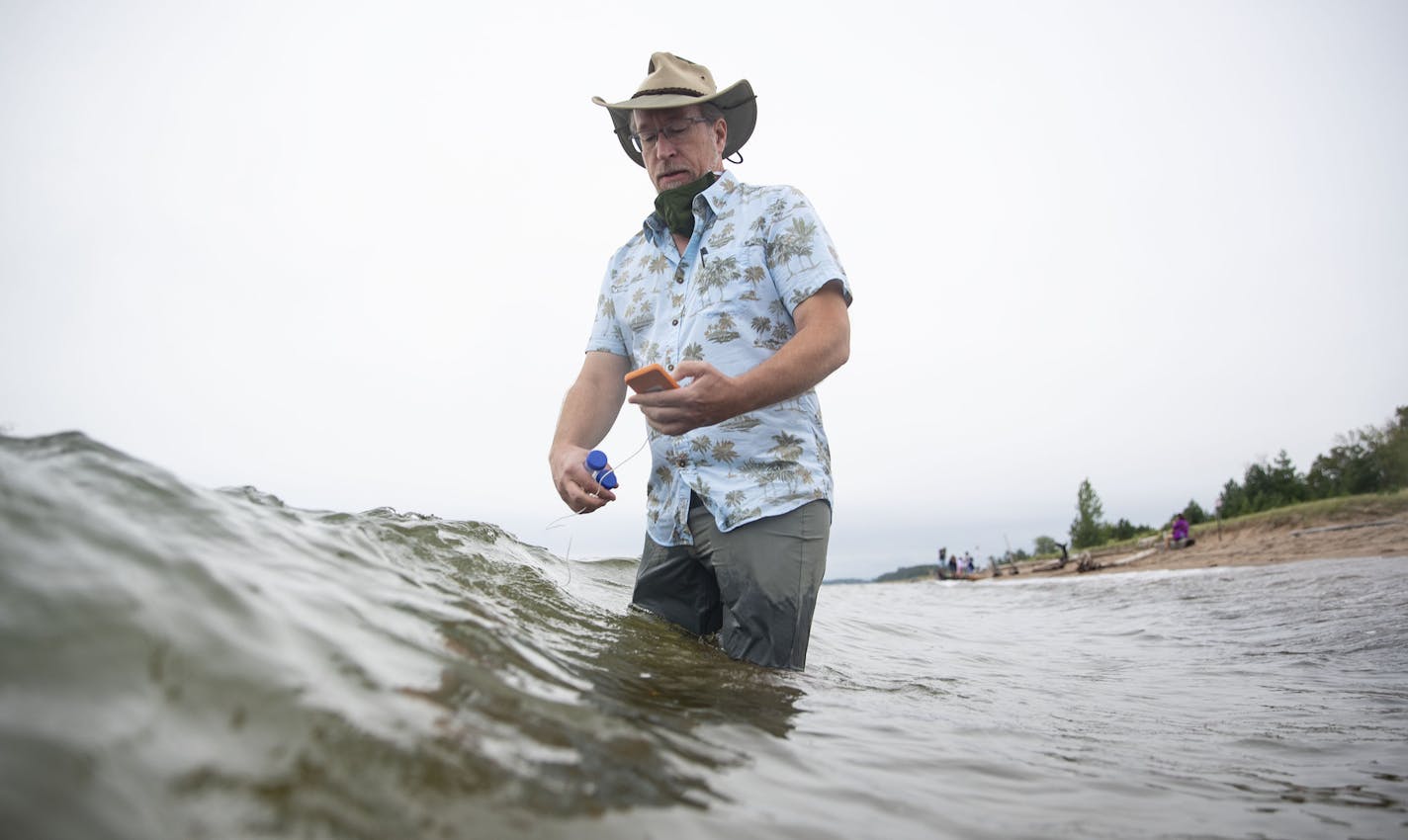 Richard Melvin, Ph.D. checked the water temperature in Lake Superior near the Park Point Beach House on Saturday morning before collecting water samples. The samples would later be tested for SARS-CoV-2, the virus that causes COVID-19. ] ALEX KORMANN • alex.kormann@startribune.com Richard Melvin, Ph.D. collected samples in Lake Superior on Park Point in Duluth on Saturday August 22, 2020. The samples will then be tested by the University of Minnesota Medical School Duluth Campus for SARS-CoV-2,