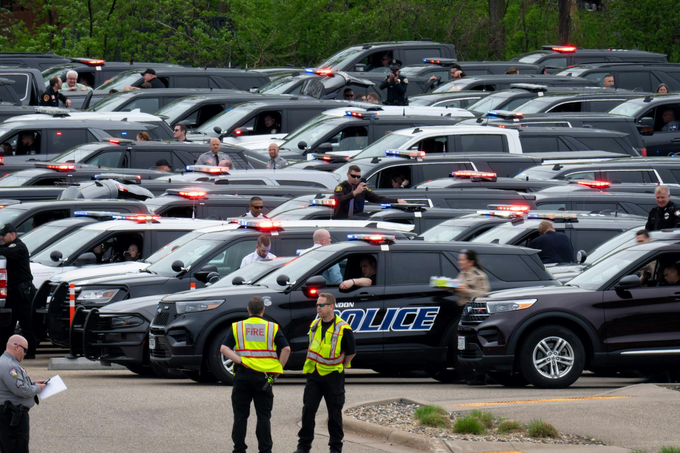 Polive vehicles waited to join the procession.