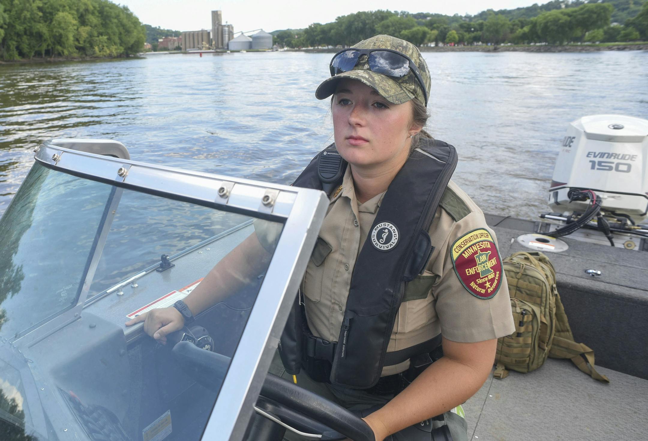 ADVANCE FOR PUBLICATION MONDAY, JULY 17, 2017 AND THEREAFTER In this Friday, June 30, 2017 photo, DNR Conservation Officer Brittany Hauser slowly motors up the Mississippi River near Red Wing, Minn., while beginning her work on the Fourth of July holiday. She is one of three new DNR COs in the region. (John Weiss/The Rochester Post-Bulletin via AP)