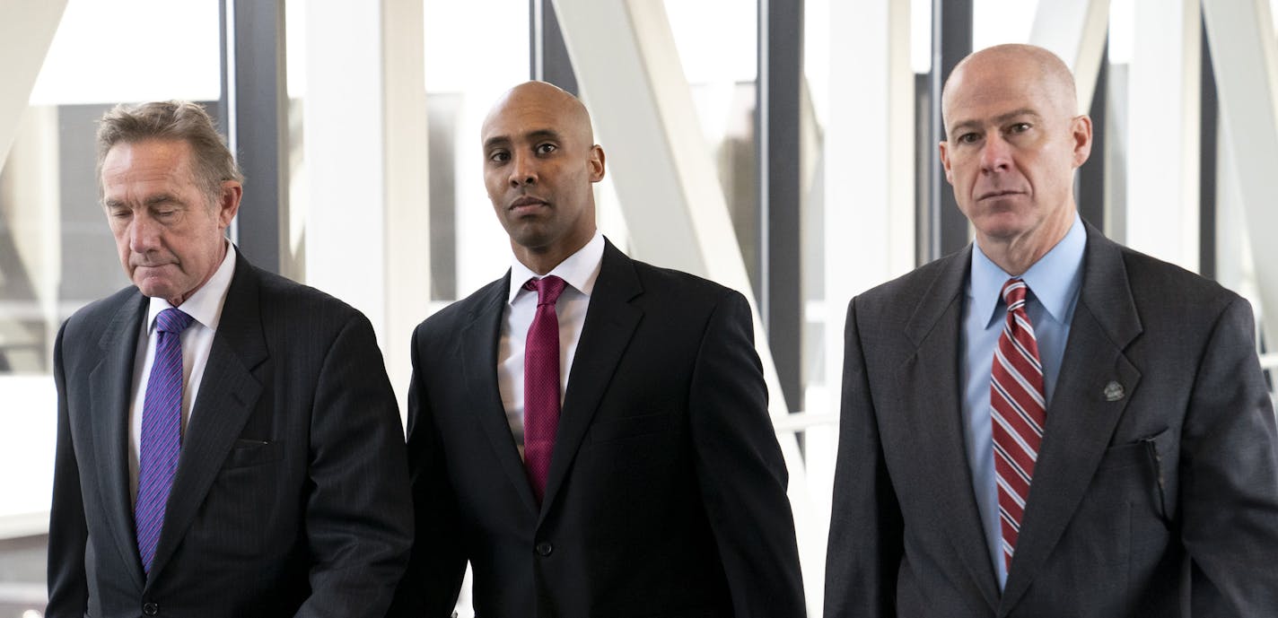 Former Minneapolis police officer Mohamed Noor, center, arrives for the first day of jury selection with his attorneys Peter Wold, left, and Thomas Plunkett, at the Hennepin County Government Center in Minneapolis, Minn., on Monday, April 1, 2019. (Renee Jones Schneider/Star Tribune via AP)