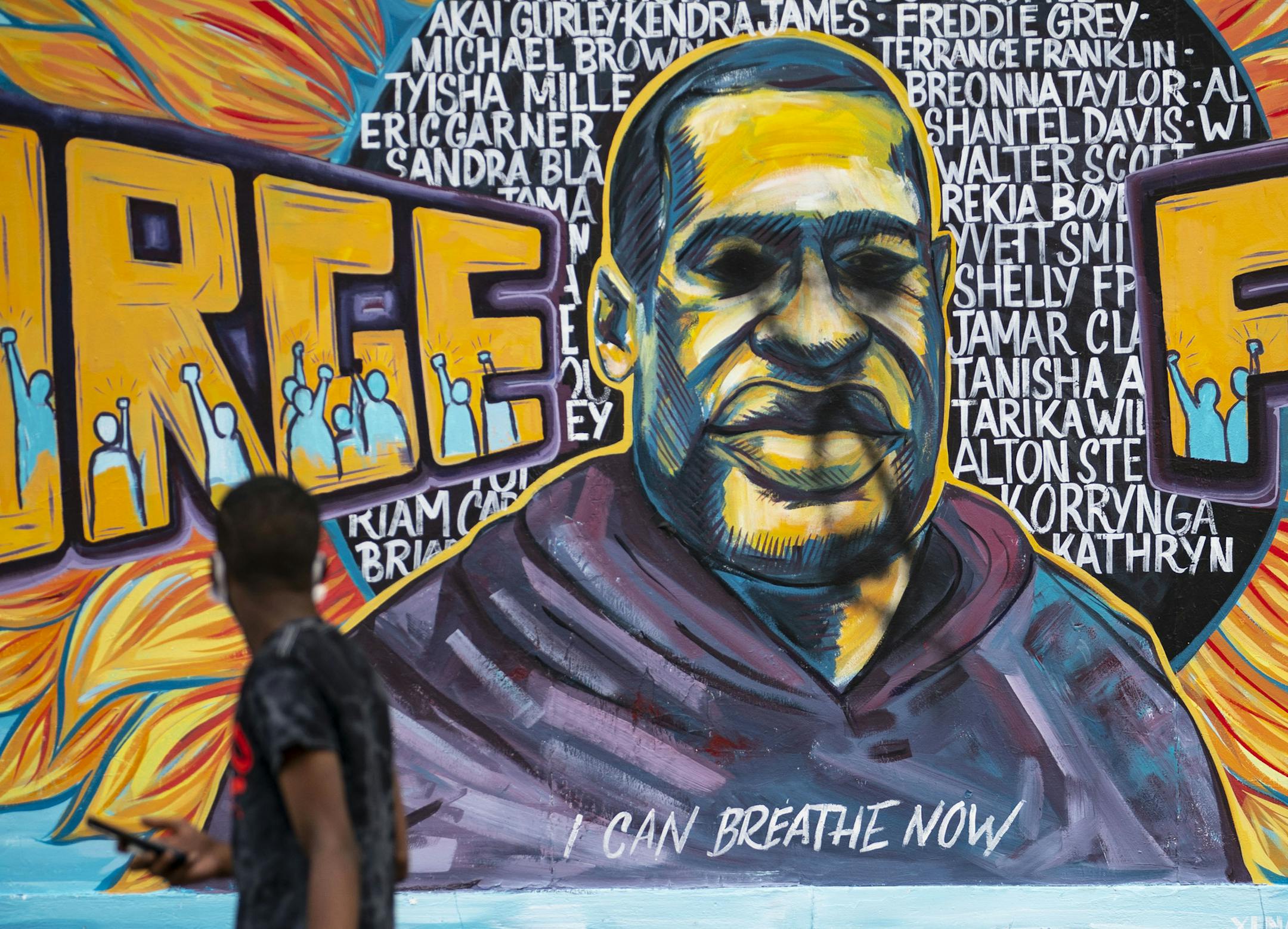 A man walked past the recently defaced George Floyd Mural in Minneapolis onThursday morning. ] ALEX KORMANN • alex.kormann@startribune.com The George Floyd Mural in Minneapolis was defaced on Tuesday night, with black spray paint covering his eyes. A tarp went up to cover it and has since been removed as of Thursday morning.
