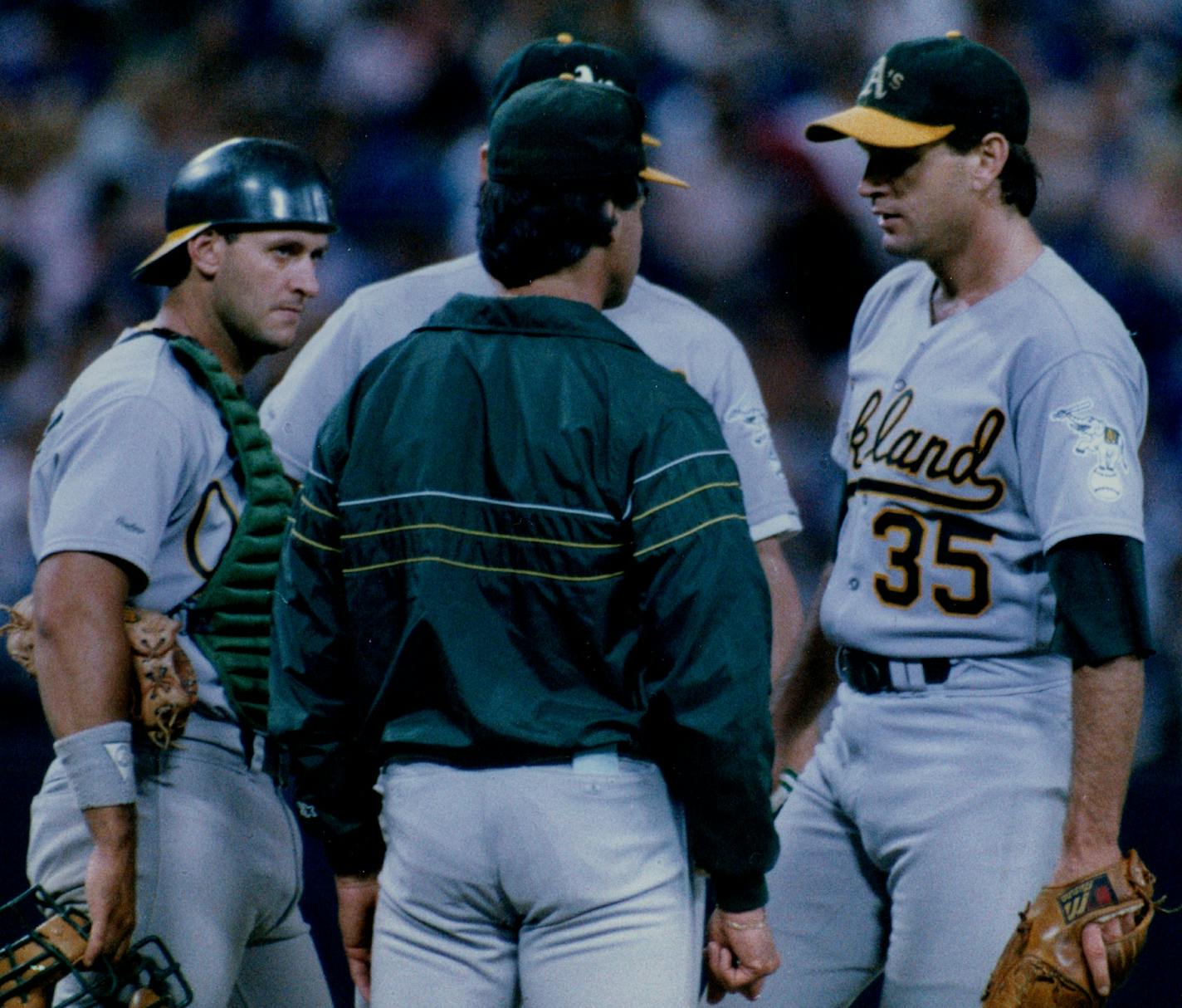 September 1988 Oakland Athletics Catcher Terry Steinbach, Manager Tony La Russa (With Back Turned), and Pitcher Bob Welch (#35) meet on the Pitchers Mound during a game against the Twins in September 1988.