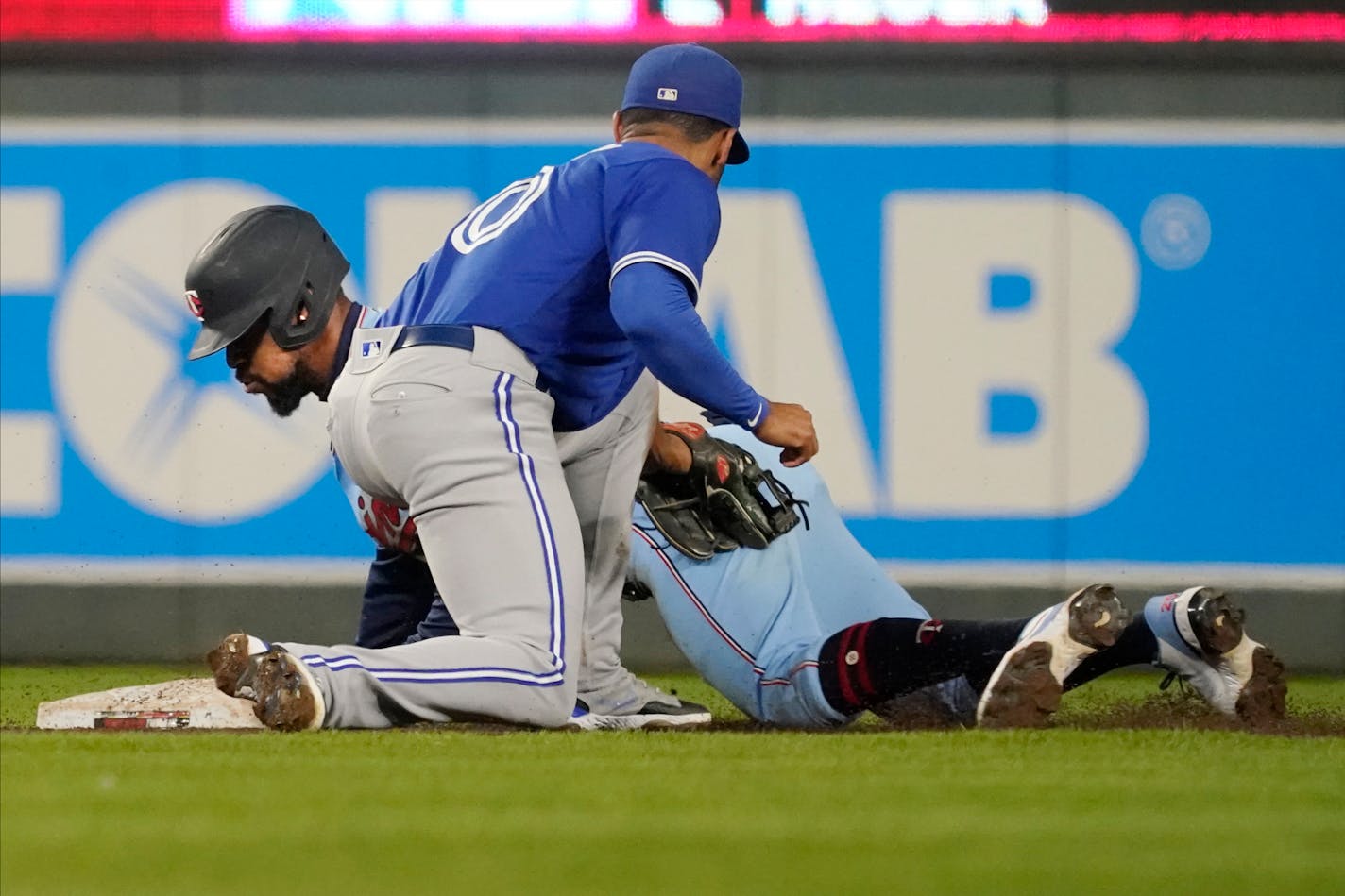 Minnesota Twins' Byron Buxton, left, steals second base, beating the tag attempt by Toronto Blue Jays second baseman Marcus Semien in the fifth inning of a baseball game, Saturday, Sept. 25, 2021, in Minneapolis. (AP Photo/Jim Mone)