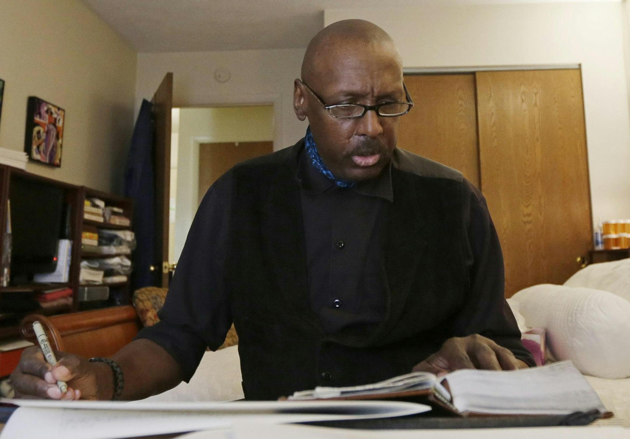 FILE - In this Tuesday, April 30, 2013 file photo, Phillip Patterson transcribes the King James Bible at this home in Philmont, N.Y. Patterson, a 63-year-old upstate New York man who has spent years writing out every word in the Bible has penning the very last lines. Patterson completed the final lines of the Book of Revelation on Saturday evening, May 11, 2013 during a ceremony at St. Peter's Presbyterian Church in Spencertown, near the Massachusetts border.(AP Photo/Mike Groll, File)